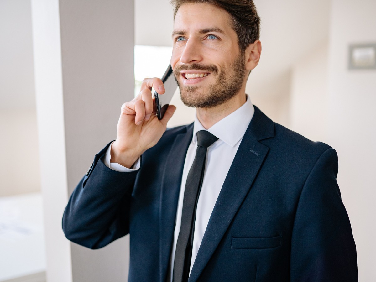 Happy customer talking on the phone with MyReplyBuddy's AI voice agent